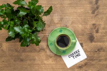 Coffee time concept. Coffee time word,cup of coffee and green plant