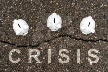 Concept financial crisis, economic depression, crash financial. Three Piggy banks standing near the crack in asphalt