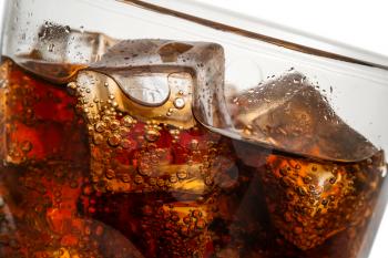 Beautiful cola with ice cubes close up in glass