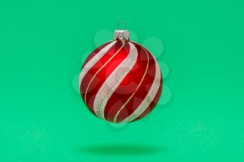 Decorative Christmas bauble hanging over a blue background.  Winter holiday decoration.