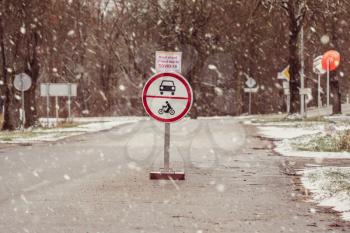 ''Road ahead closed due to COVID-19'' road sign stand on the entry to small town