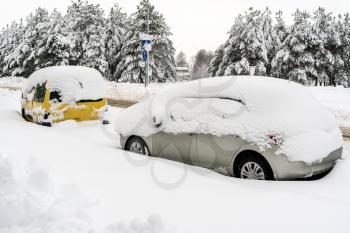 The cars on the street under snow after heavy snowfall