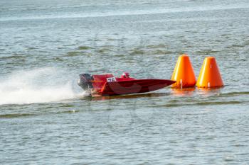 Red powerboat go fast along the lake in Powerboat competition