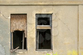 Abandoned industrial building. Concrete wall  and two windows without glass