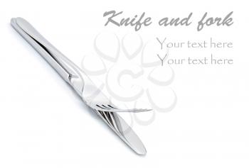 Two utensils-knife and fork on the white background with space for text