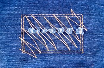 Abstract pattern embroidered on denim in the form of a rectangle and  a zigzag
