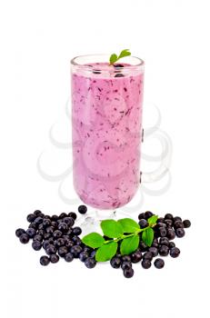 Glass goblet with a milkshake, berries and green sprig of blueberries isolated on white background
