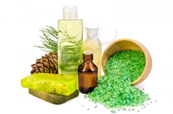 Cedar oil in a bottle, cedar cones with branch, two green homemade soap, salt in a wooden bowl, lotion, shower gel isolated on white background
