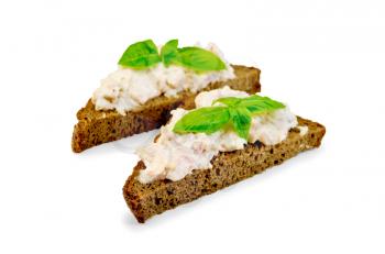 Sandwiches on two pieces of rye bread with cream of salmon and mayonnaise, basil, isolated on white background