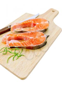 Two pieces of trout with rosemary and a knife on a wooden board isolated on white background