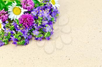 Various wild flowers on a background of rough brown wrapping paper