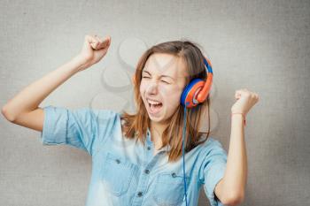 woman listening gesture muzykuv headphones. isolated on gray background