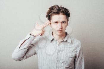 young man committing suicide with imaginary gun