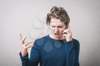 Angry business man screaming on cell mobile phone, conversation