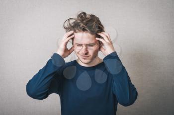 Man thinks headache. Gray background.