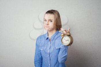 girl holding alarm clock