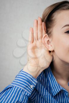 Young woman surprised trying to hearing something