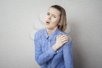 Young woman with pain in her shoulder