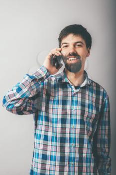 bearded man talking on the phone