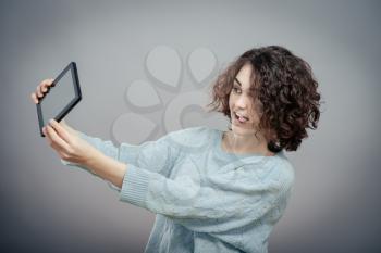 Woman taking photo with tablet PC, isolated