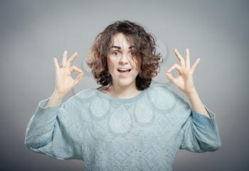 successful young woman showing okay sign. isolated 