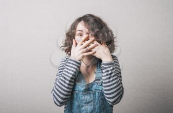 girl laughing and covers face