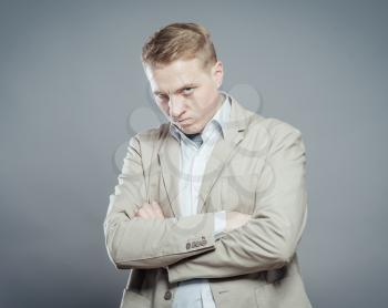 Closeup portrait of a very sad, depressed, alone, disappointed man resting his face on hands, side profile isolated on graybackground 