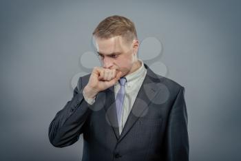 Closeup portrait of an angry guy biting his fist