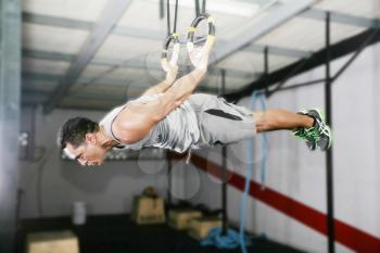 The sportsman the guy, carries out difficult exercise, sports gymnastics 
