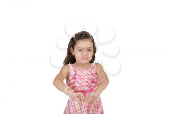 portrait of a beautiful little girl with thumb down isolated on white background