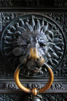Ancient metal lion head on the door to catholic church in Cologne, Germany
