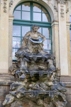 Closeup half naked faunus statues fountain at Zwinger palace in Dresden, Germany
