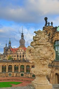 Closeup stone figure and Residenzschloss (city hall) on the back at Zwinger palace in Dresden, Germany
