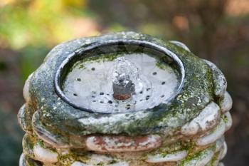 Artificial water spring in stoned tube and metal tap
