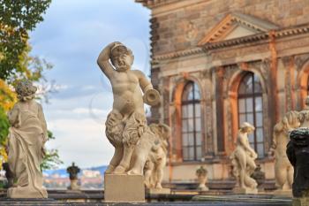 Closeup stone statue of child faunus at Zwinger palace in Dresden, Germany
