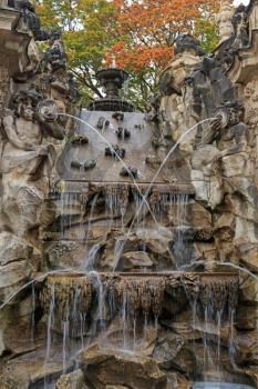 Fountain with faunus statues and streaming water at Zwinger palace, Dresden, Germany
