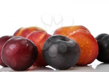Juicy nectarines, plums and peaches on white background 