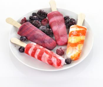 colorful  ice cream pops with frozen berries
