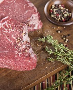 Raw beef steak with herbs and spices