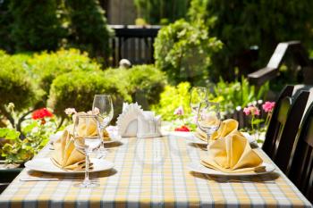 Outdoor restaurant dining table. Place setting