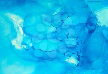 Abstract painted liquid light blue.Colorful background hand drawn with bright inks and watercolor paints. Color splashes and splatters create uneven artistic modern design.