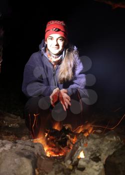 Royalty Free Photo of a Girl at a Campfire