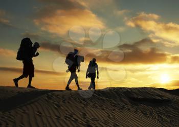 Royalty Free Photo of a Group of Backpackers at Sunset in the Desert