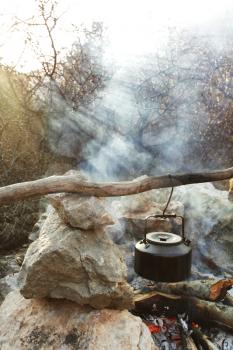 Royalty Free Photo of an Old Kettle Over A Fire