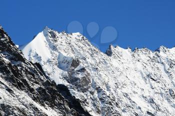 Royalty Free Photo of a Snow Covered Mountain Peak
