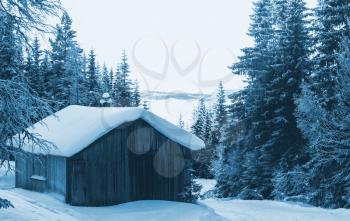 wooden hut in the mountains at winter