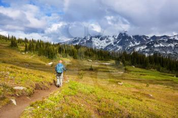 Hiking man in the mountains  outdoor active lifestyle travel adventure vacations summertime. Hike concept