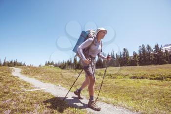 Backpacker in a hike in the summer mountains