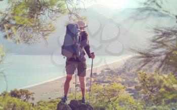 Backpacker in a hike in the summer mountains