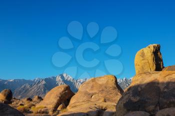 Hiker in unusual stone formations in Alabama hills, California, USA